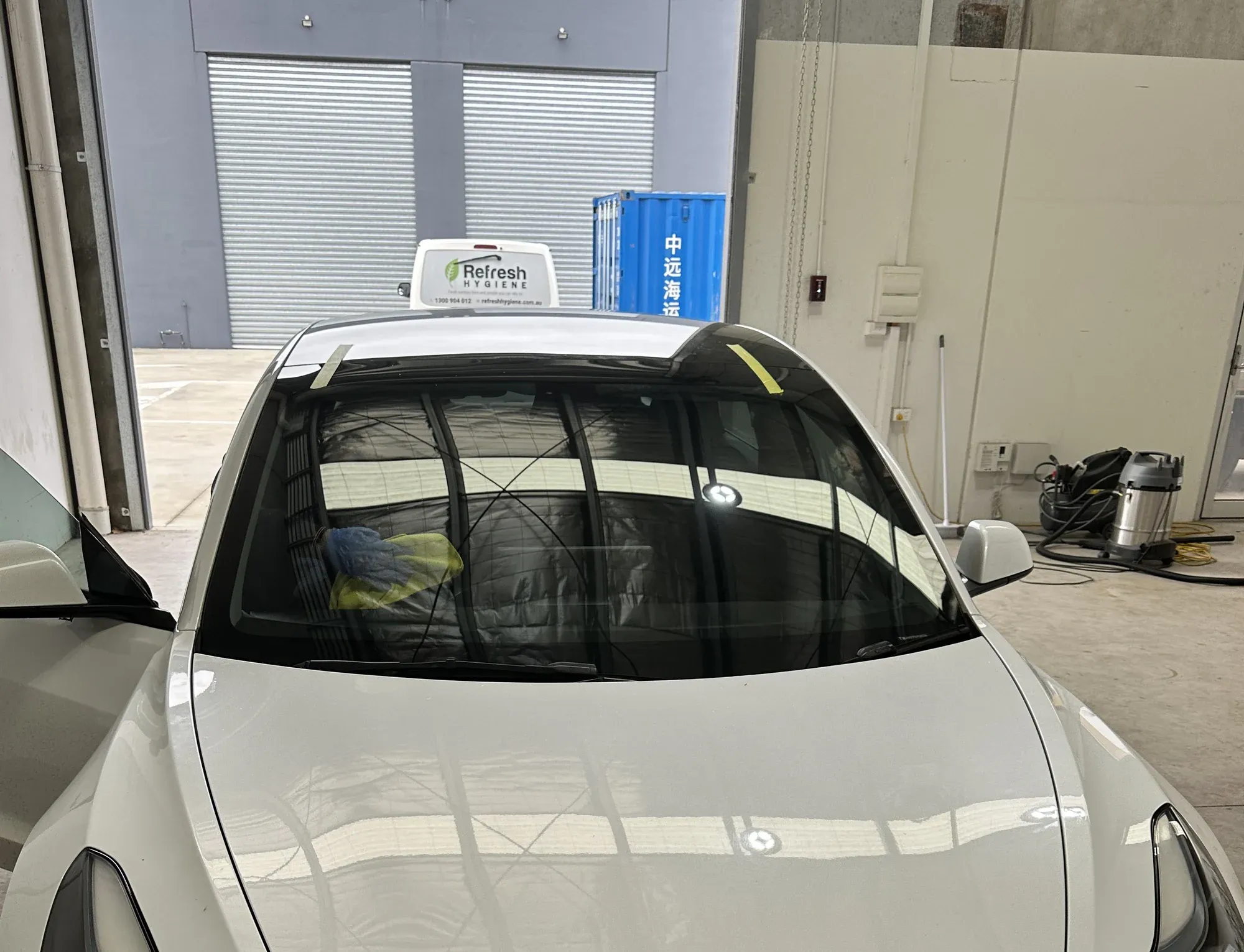 Newly fitted front windscreen on a white sedan during a mobile replacement in Melbourne