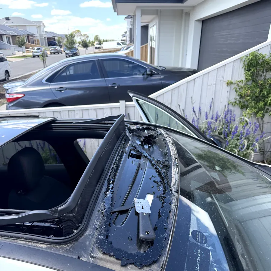 Rear quarter glass removed from a sedan, showing the cleaned bonding frame