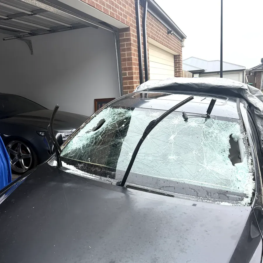 Severely shattered front windscreen on a vehicle before replacement