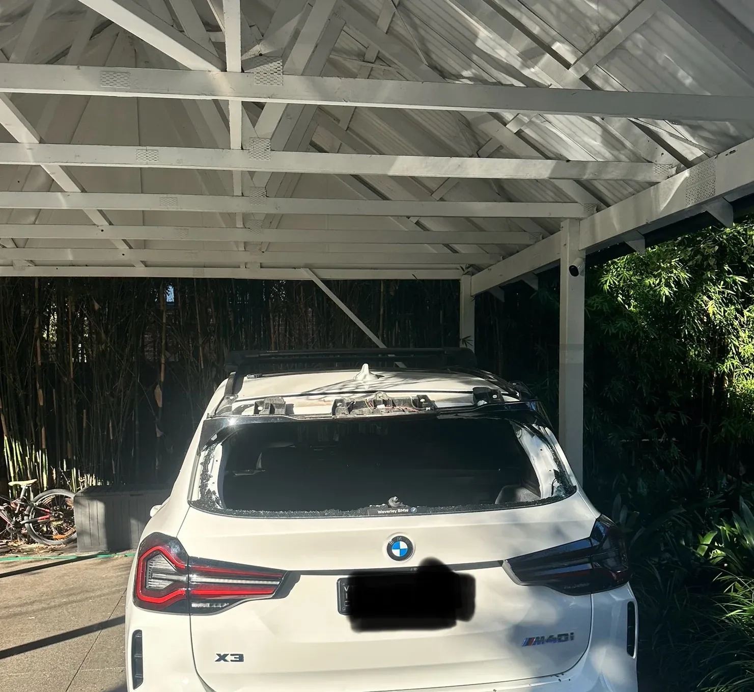 Mobile auto glass replacement carried out under a carport at a Melbourne home