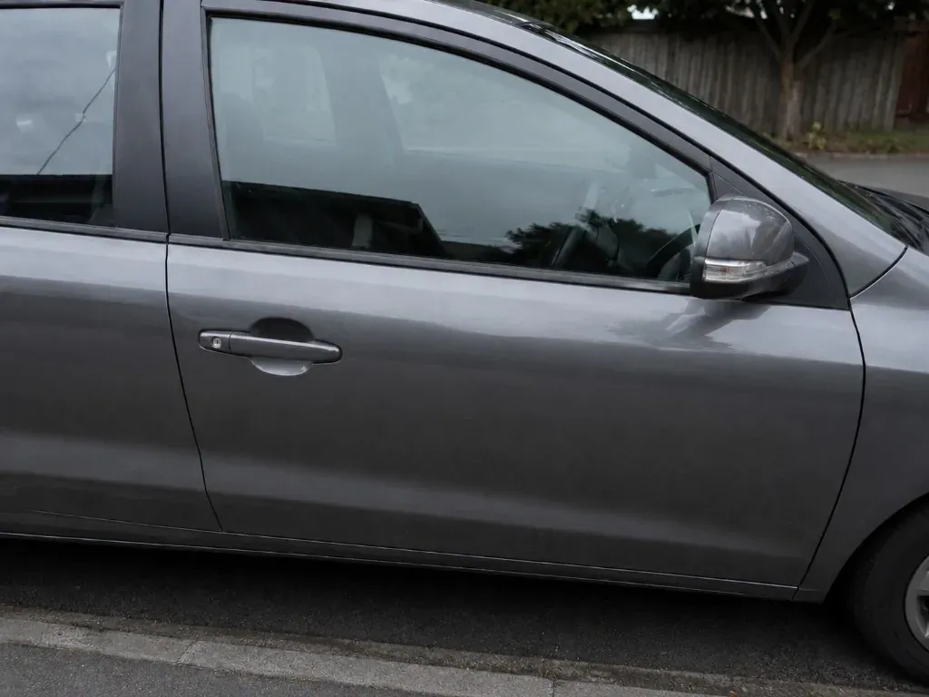 After: grey car with a newly fitted clear front side window